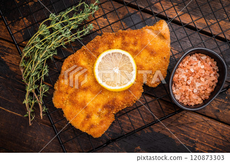 Fried Wiener chicken schnitzel steak, breaded meat. wooden background. top view 120873303