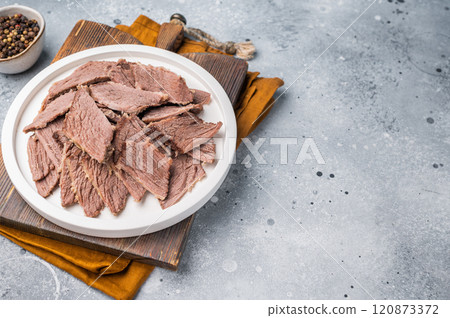 Corned sliced beef meat in a plate. gray background. top view Corned sliced beef meat in a plate. gray background. top view 120873372
