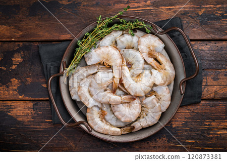 Uncooked Raw white tiger shrimps prawns in a tray. Top view. Wooden background 120873381