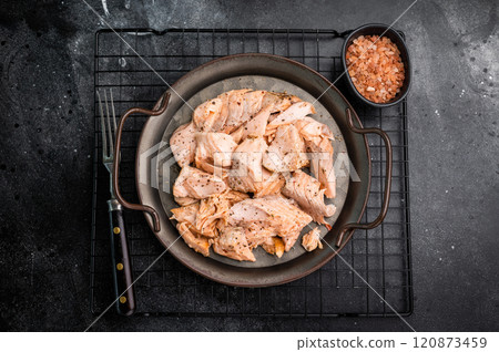 Roast salmon fillet, pulled fish meat on a steel tray. black background. Top view 120873459