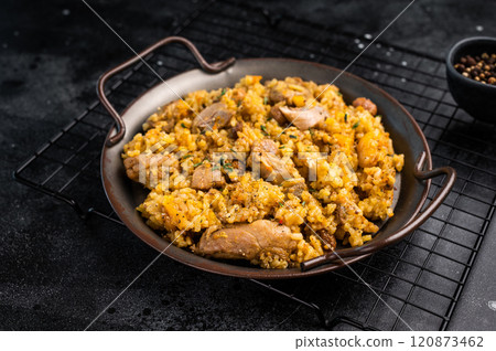 Arabic national rice food pilaf or plov, cooked with fried lamb and beef meat. black background. top view Arabic national rice food pilaf or plov, cooked with fried lamb and beef meat. black background. top view 120873462
