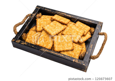 Square salty crackers in wooden tray isolated on white background, top view Square salty crackers in wooden tray isolated on white background, top view 120873607