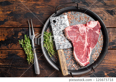 Raw Florentine steak or T bone steak, marbled beef meat in a steel kitchen tray. Wooden background. Top view Raw Florentine steak or T bone steak, marbled beef meat in a steel kitchen tray. Wooden background. Top view 120873718