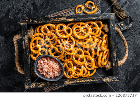 Snack box with salty pretzels crackers. Black background. Top view 120873737