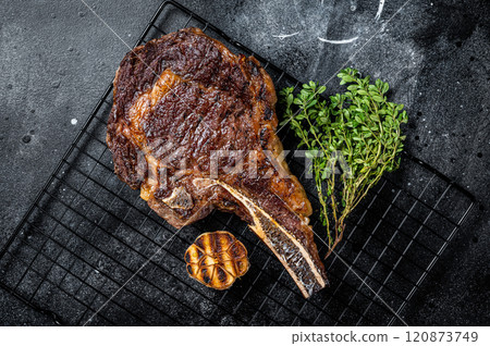 BBQ Grilled Tomahawk or rib eye with bone beef steak. Black background. Top view 120873749