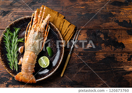 Gourmet dinner with Spiny lobster or sea crayfish on a plate. Wooden background. Top view. Copy space Gourmet dinner with Spiny lobster or sea crayfish on a plate. Wooden background. Top view. Copy space 120873760