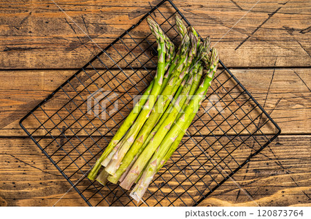 Organic green asparagus ready for cooking. Wooden background. Top view 120873764