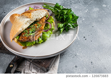 Balik Ekmek Turkish fish sandwich with grilled mackerel fillet in a bun. Gray background. Top view. Copy space 120873883