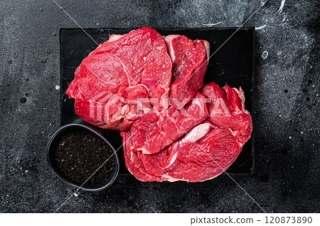 Raw Mutton fillet steaks from leg, uncooked lamb meat. Black background. Top view 120873890