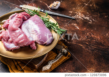 Fresh skinless raw Turkey thigh fillet meat with spices. Dark background. Top view. Space for text Fresh skinless raw Turkey thigh fillet meat with spices. Dark background. Top view. Space for text 120873896