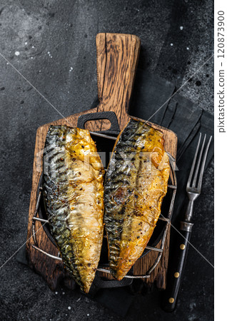 Grilled mackerel fish fillet on a grill. Black background. Top view Grilled mackerel fish fillet on a grill. Black background. Top view 120873900