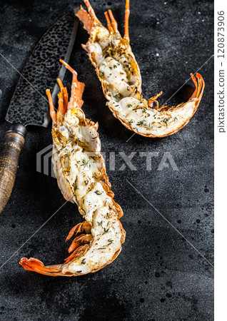 BBQ Grilled Spiny lobster sliced on a cutting board Black background. Top view BBQ Grilled Spiny lobster sliced on a cutting board Black background. Top view 120873906