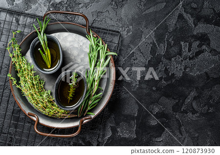 Assorted fresh herbs with olive oil. Top view. Dark background. Copy space. 120873930