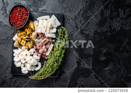 Seafood assorted platter, mix of mussels, clams, squid, octopus, shrimps and prawn. Black background. Top view. Copy space Seafood assorted platter, mix of mussels, clams, squid, octopus, shrimps and prawn. Black background. Top view. Copy space 120873938