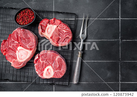 Fresh Osso buco Veal shank ready for cooking, raw cross cut veal shank. Black background. Top view. Copy space 120873942