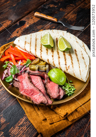 Mexican fajitas for grilled beef steak and vegetables. Wooden background. top view 120873952