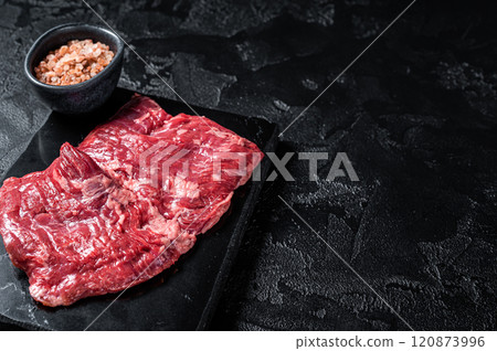 Skirt or Machete beef steak, raw meat ready for cooking. Black background. Top view. Copy space 120873996