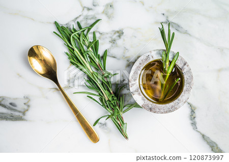 Flavoring: extra virgin olive oil with thyme and rosemary. Top view. White background Flavoring: extra virgin olive oil with thyme and rosemary. Top view. White background 120873997