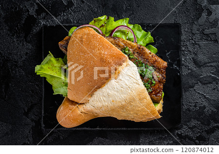 Turkish fish sandwich with grilled mackerel fillet Balik Ekmek. Black background. Top view Turkish fish sandwich with grilled mackerel fillet Balik Ekmek. Black background. Top view 120874012