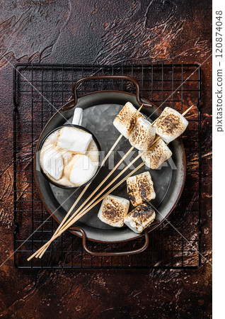Fried Marshmallow on the sticks with Cup of coffee. Dark background. Top view 120874048