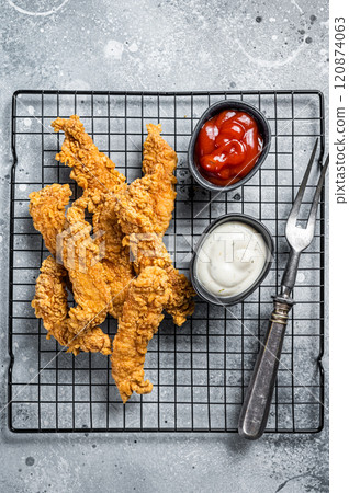 Dip fried Chicken Steak Fingers strips with sauces. Gray background. Top view Dip fried Chicken Steak Fingers strips with sauces. Gray background. Top view 120874063