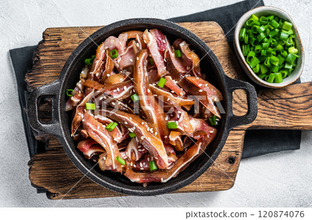 Fried spicy pork pig ears served in a frying pan. white background. Top view Fried spicy pork pig ears served in a frying pan. white background. Top view 120874076