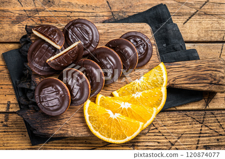 Chocolate Jaffa Cakes with Orange Flavored Marmalade. Wooden background. Top view 120874077