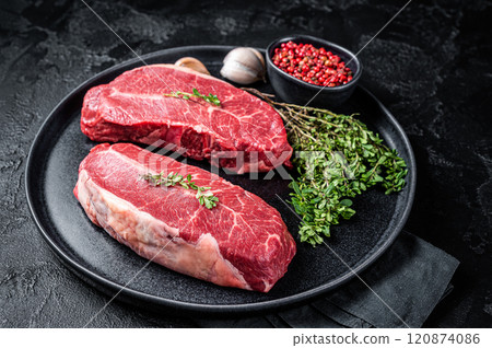 Dry aged Raw top blade flat Iron beef meat steaks. Black background. Top View 120874086