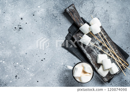 Marshmallow on the stick ready for BBQ. Gray background. Top view. Copy space Marshmallow on the stick ready for BBQ. Gray background. Top view. Copy space 120874098