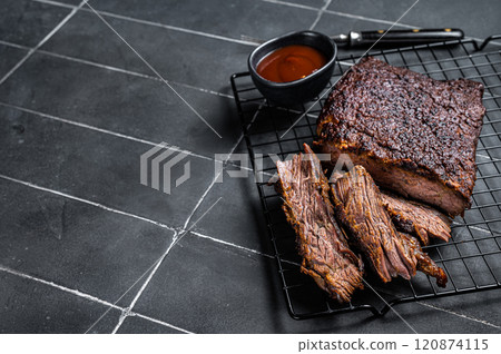 Chopped Beef Brisket barbecue, Traditional meat rubbed with spices and smoked in a Texas smoker. Black background. Top view. Copy space Chopped Beef Brisket barbecue, Traditional meat rubbed with spices and smoked in a Texas smoker. Black background. Top view. Copy space 120874115