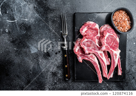 Uncooked lamb mutton chops, raw meat steaks. Black background. Top view. Copy space Uncooked lamb mutton chops, raw meat steaks. Black background. Top view. Copy space 120874116