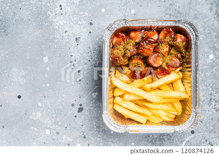 Traditional German currywurst with french fry served take away. Gray background. Top view. Copy space Traditional German currywurst with french fry served take away. Gray background. Top view. Copy space 120874126