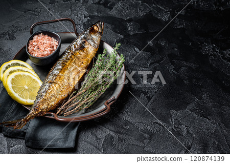 Baked Mackerel Scomber fish in steel tray with thyme and lemon. Black background. Top view. Copy space Baked Mackerel Scomber fish in steel tray with thyme and lemon. Black background. Top view. Copy space 120874139