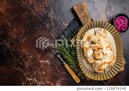 Grilled chicken on bamboo skewers, Shashlik with thyme and spices. Dark background. Top view. Copy space Grilled chicken on bamboo skewers, Shashlik with thyme and spices. Dark background. Top view. Copy space 120874148