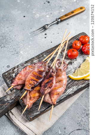 Japanese Barbecue Squid on stick. Gray background. Top view Japanese Barbecue Squid on stick. Gray background. Top view 120874152