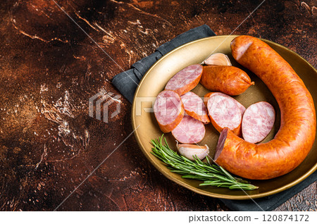 Polish Smoked sausage in a steel plate. Dark background. Top view. Copy space Polish Smoked sausage in a steel plate. Dark background. Top view. Copy space 120874172