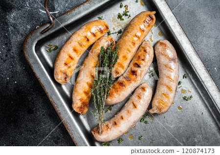 Grilled Bratwurst and Chorizo sausages on a steel serving tray. Black background. Top view Grilled Bratwurst and Chorizo sausages on a steel serving tray. Black background. Top view 120874173