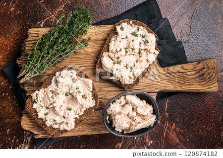 Cod Liver open Sandwich on wooden board. Dark background. Top view Cod Liver open Sandwich on wooden board. Dark background. Top view 120874182
