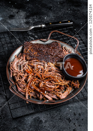 Slow Cooked Pulled Beef, Traditional meat rubbed with spices and smoked in a Texas smoker. Black background. Top view 120874184