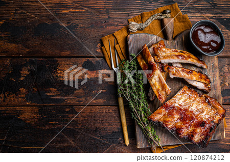 Grilled pork Baby Back spare ribs on a wooden board. Wooden background. Top view. Copy space 120874212