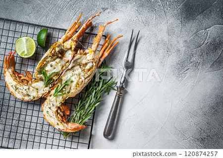 Barbecue grilled and sliced Spiny lobster or sea crayfish with herbs. White background. Top view. Copy space Barbecue grilled and sliced Spiny lobster or sea crayfish with herbs. White background. Top view. Copy space 120874257