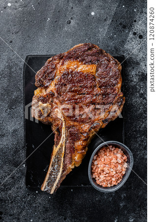 Grilled cowboy or rib eye with bone beef steak. Black background. Top view 120874260