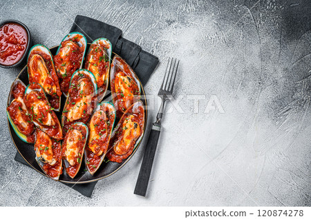 Large green mussels cooked in tomato sauce with garlic, parsley and lemon. White background. Top view. Copy space Large green mussels cooked in tomato sauce with garlic, parsley and lemon. White background. Top view. Copy space 120874278