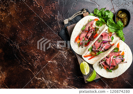 Carne Asada Tacos with grilled steak, green sauce, jalapenos and onion, Mexican food. Dark background. top view. copy space 120874280