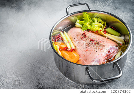 Cooking of Eisbein from Raw pork Hock ham, shank with vegetables and herbs. White background. Top view. Copy space 120874302