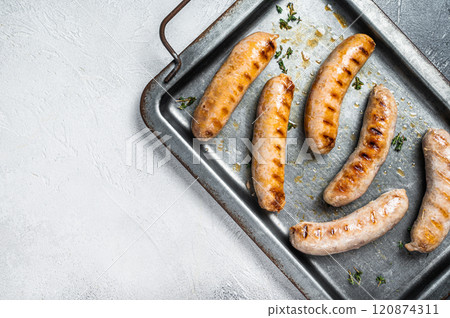 BBQ Grilled Bratwurst and Bockwurst pork meat sausages on a steel serving tray. White background. Top view. Copy space BBQ Grilled Bratwurst and Bockwurst pork meat sausages on a steel serving tray. White background. Top view. Copy space 120874311