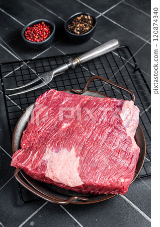 Raw piece of marble beef brisket meat with spices. Black background. Top view 120874340