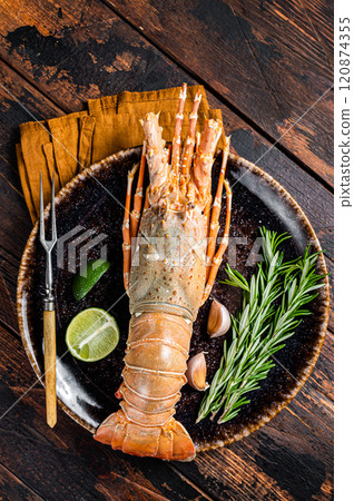Gourmet dinner with Spiny lobster or sea crayfish on a plate. Wooden background. Top view Gourmet dinner with Spiny lobster or sea crayfish on a plate. Wooden background. Top view 120874355