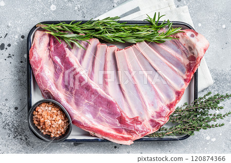 Ready for cooking Rack of lamb, raw mutton ribs with herbs. Gray background. Top view 120874366