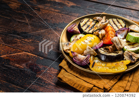 Various grilled Vegetables, bell pepper, zucchini, eggplant, onion and tomato. Wooden background. Top view. Copy space Various grilled Vegetables, bell pepper, zucchini, eggplant, onion and tomato. Wooden background. Top view. Copy space 120874392